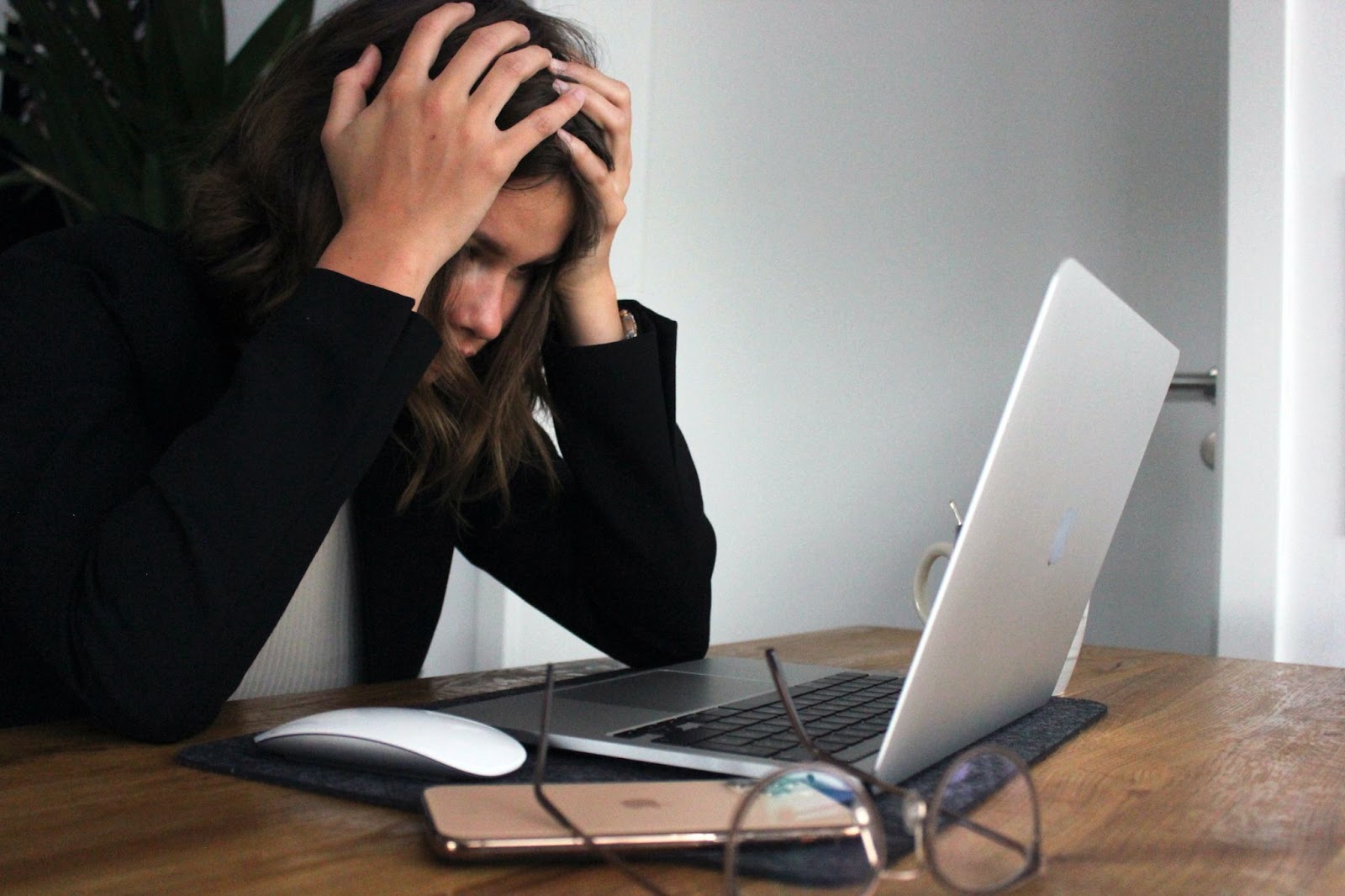 Woman sitting at computer stressed out in need for herbs for stress relief.